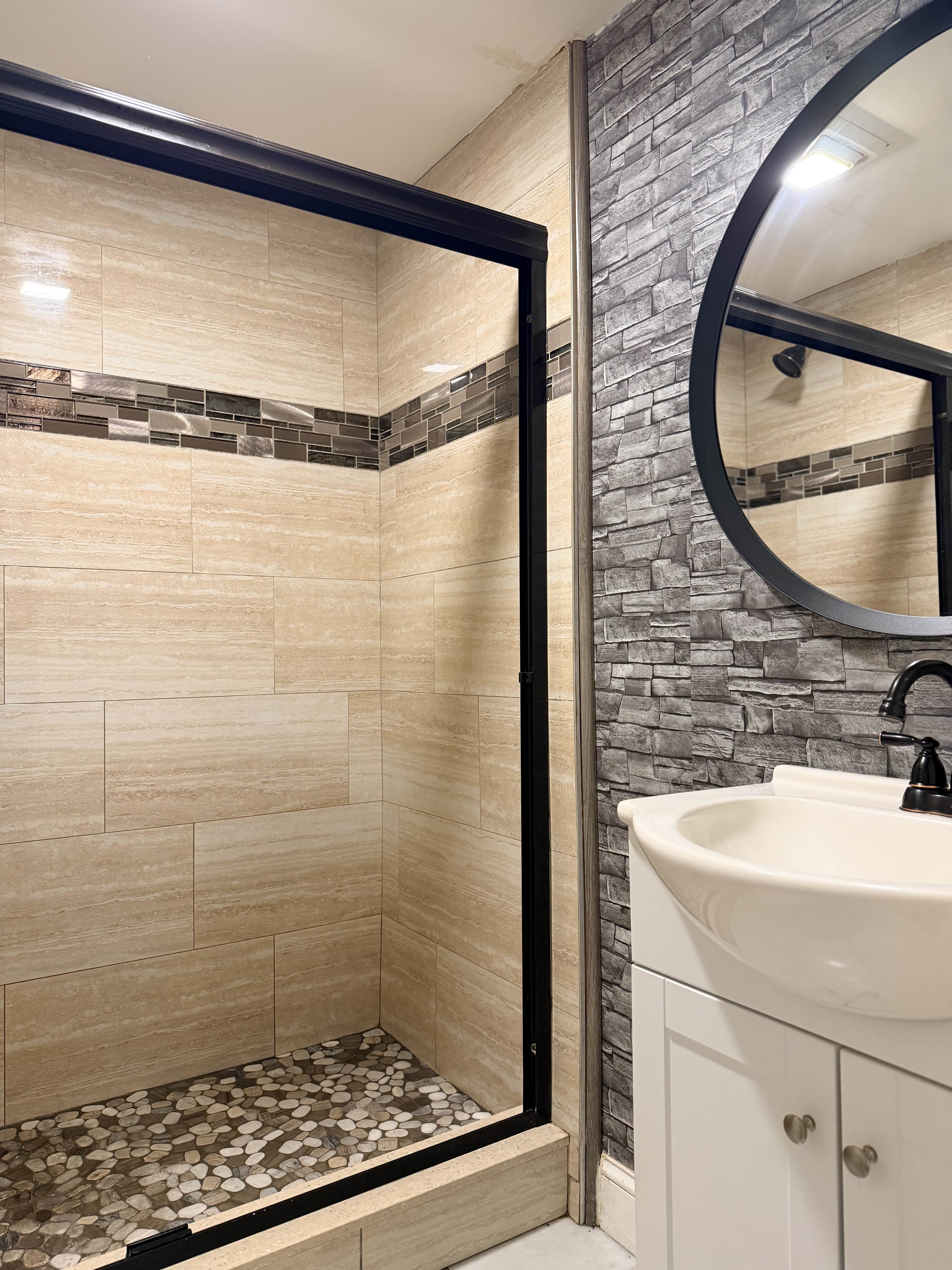 Clean tiled shower with glass enclosure